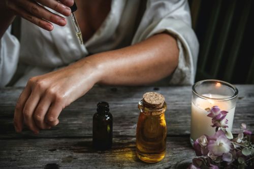 A woman applying topical olive oil
